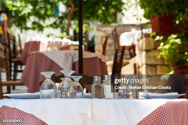 empty table waiting for turists in athens, greece - plaka greek cafe stock pictures, royalty-free photos & images