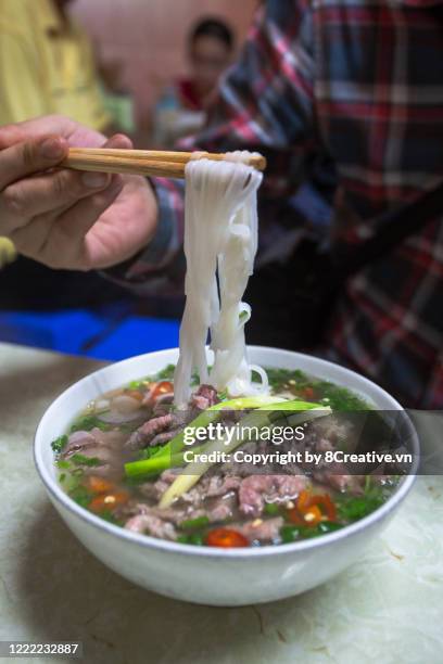 close up of a steaming bowl of pho noodle soup - pho soup ストックフォトと画像