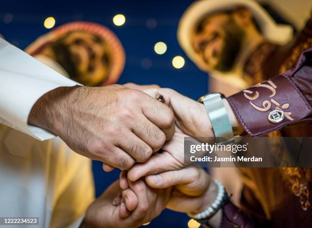 two young arab men greeting happy eid mubarak - arab festival stock pictures, royalty-free photos & images