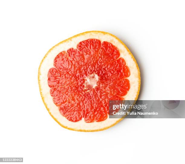 ripe slice of pink grapefruit citrus fruit isolated on white background. red grapefruit segment ready to eat. ripe cut citrus. sliced grapefruit on white background. - half full stock pictures, royalty-free photos & images