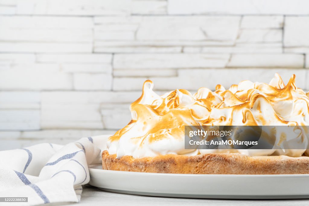 Lemon tart pie with meringue cream. Traditional American cake. Homemade baking. Copy space