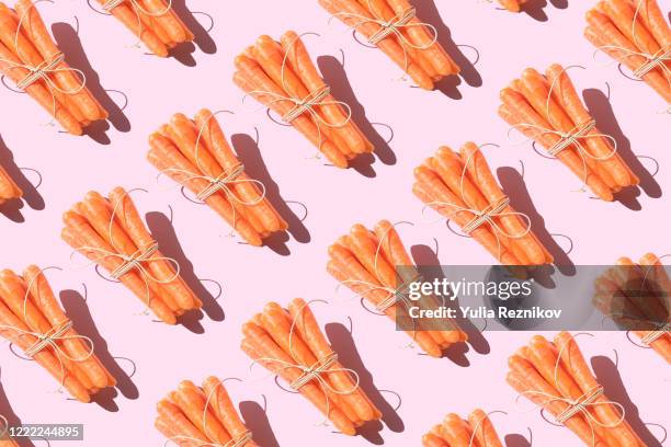 repeated bunch of carrots on the pink background - babymorot bildbanksfoton och bilder