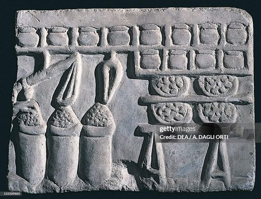 Relief depicting display of goods in shop