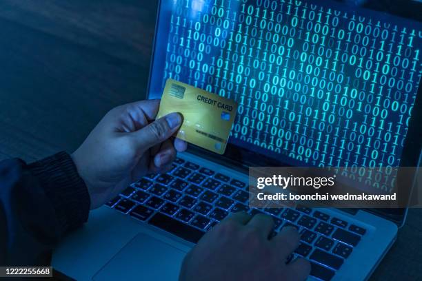 hands of anonymous hackers holding credit card - cloning device stock pictures, royalty-free photos & images