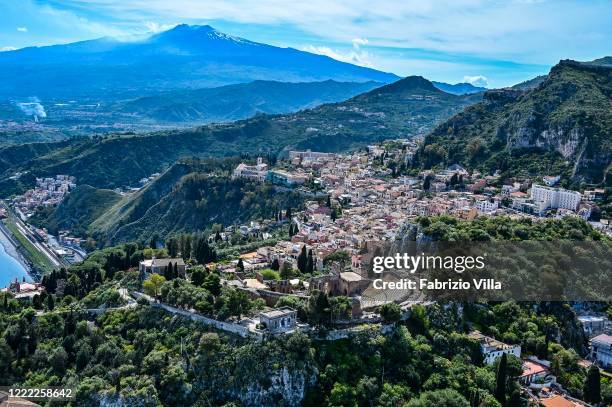 Aerial view of Taormina with the Teatro Antico and the Etna volcano in the backgroundon May 01, 2020 in Taormina, Italy. Italy is still on lockdown...