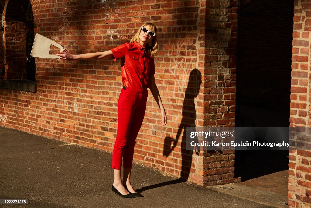 Woman in a red suit in DUMBO Brooklyn