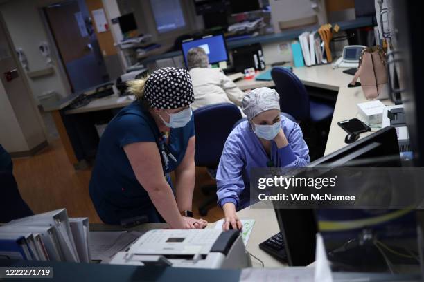 Nurses work on a computer while treating patients with coronavirus in the intensive care unit at a hospital on May 1, 2020 in Leonardtown, Maryland....