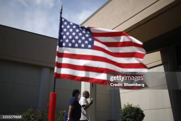 Voters arrive outside a polling location in Louisville, Kentucky, U.S., on Tuesday, June 23, 2020. Counties today opened fewer than 200 polling...