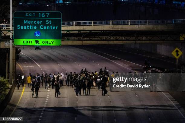 Protesters walk down Interstate 5 after marching there from the area known as the Capitol Hill Organized Protest on June 23, 2020 in Seattle,...