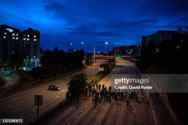 Protesters walk down Interstate 5 after marching there from the area known as the Capitol Hill Organized Protest on June 23, 2020 in Seattle,...