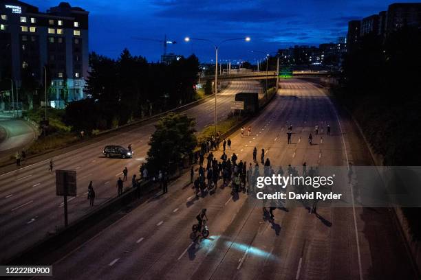 Protesters walk down Interstate 5 after marching there from the area known as the Capitol Hill Organized Protest on June 23, 2020 in Seattle,...