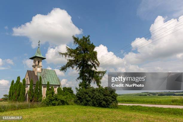 Old church is seen as fields are cultivated in agricultural countryside in Swietokrzyskie region in south-east of Poland as the agricultural season...