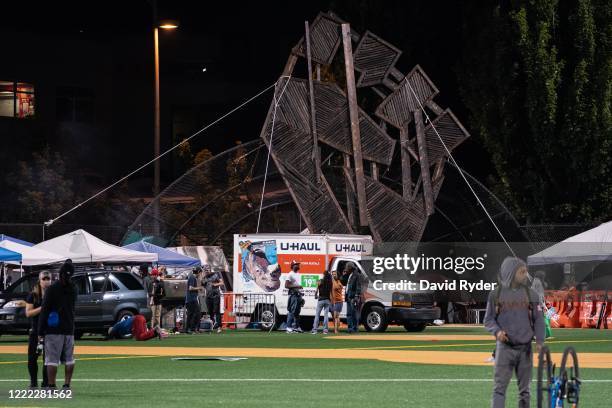 Haul truck sits parked next to public art in the shape of a fist in the area known as the Capitol Hill Organized Protest on June 23, 2020 in Seattle,...