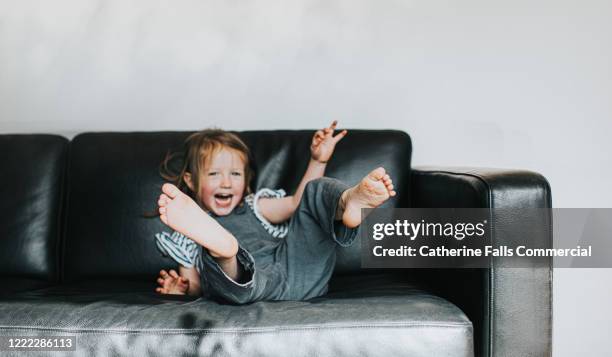 sofa flop - barefoot child stock pictures, royalty-free photos & images