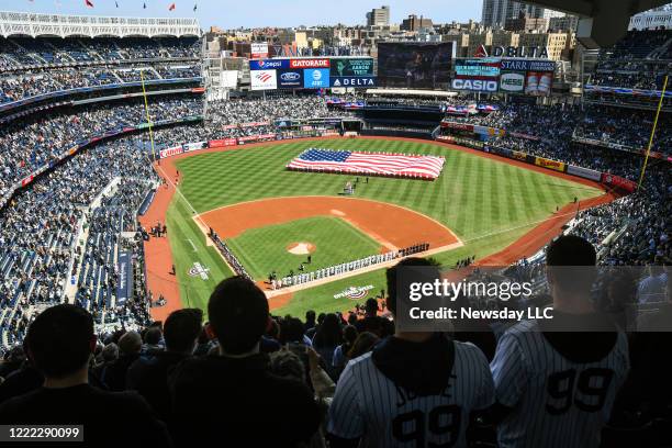 New York Yankees and the Baltimore Orioles line up for opening day ceremonies at the start of the Yankees home opener at Yankee Stadium in the Bronx,...