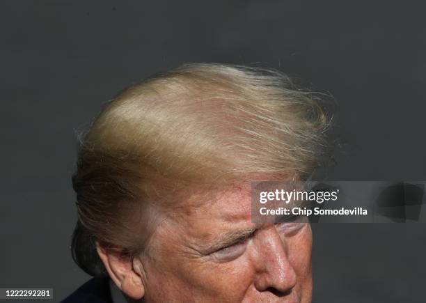 President Donald Trump talks to journalists on the South Lawn while departing the White House for Camp David May 01, 2020 in Washington, DC....