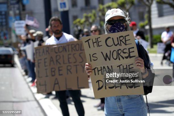 Demonstrators protest California Gov. Gavin Newsom's continued statewide shelter in place order outside of San Francisco City Hall on May 01, 2020 in...