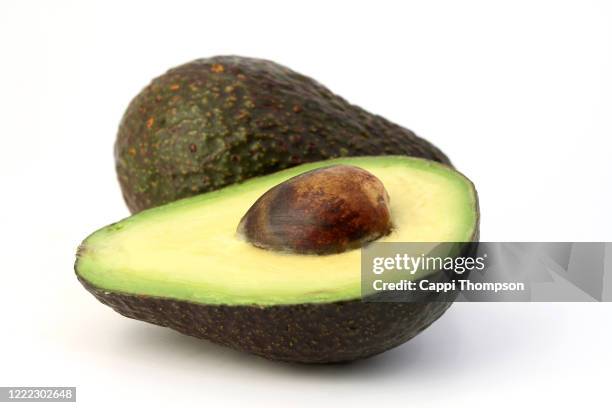 sliced avocado on white background - avocado fotografías e imágenes de stock