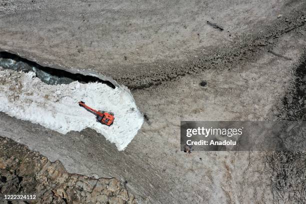 Drone photo shows an aerial view of a road as Van metropolitan municipality staff conducts road opening works with a excavator bucket on tableland...