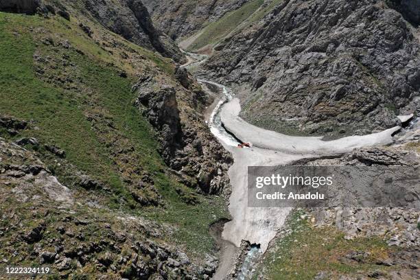 Drone photo shows an aerial view of a road as Van metropolitan municipality staff conducts road opening works with a excavator bucket on tableland...