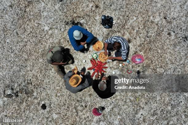 Drone photo shows an aerial view of Van metropolitan municipality staff have a launch break on a mass of snow during the road opening works with a...