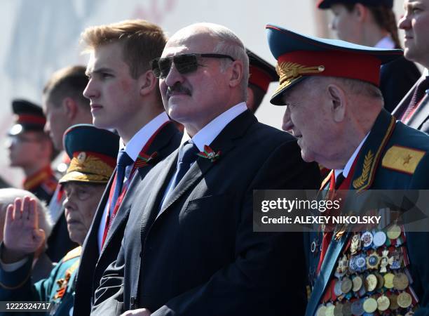 Belarus President Alexander Lukashenko and his son Nikolai watch a military parade, which marks the 75th anniversary of the Soviet victory over Nazi...