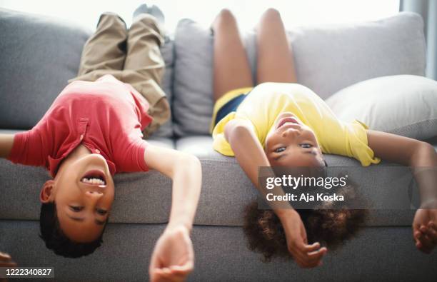 children lying down on the sofa at home. - lying on back girl on the sofa imagens e fotografias de stock