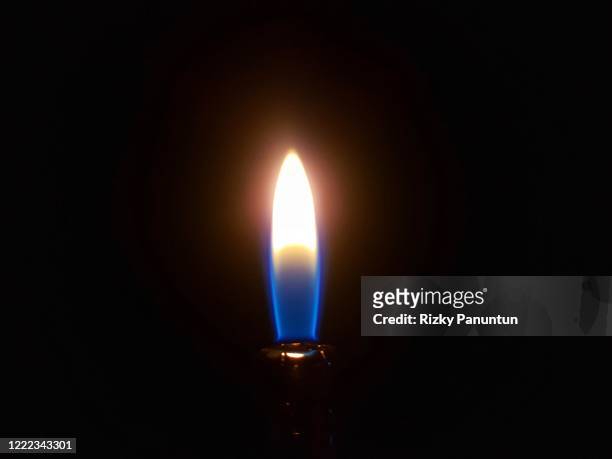 close-up of fire against black background - candle flame stockfoto's en -beelden