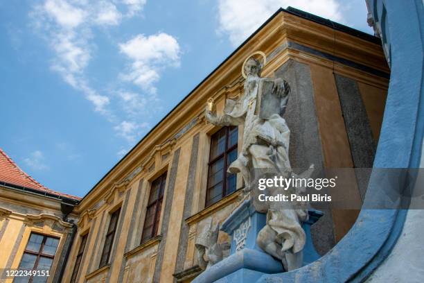 abbey church dürnstein's exterior with holy sculpture - dürnstein stock pictures, royalty-free photos & images