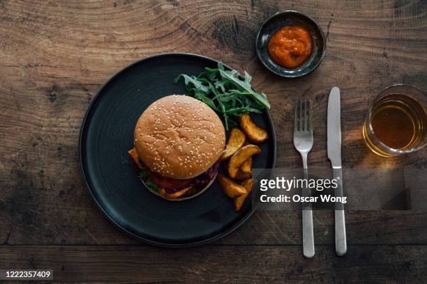 flat lay shot of burger on dining table - ハンバーグ　皿 ストックフォトと画像