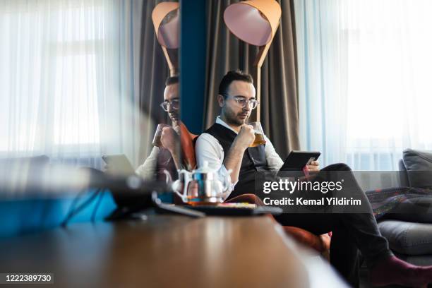 cropped shot of a handsome young man making notes while working at home - resourceful stock pictures, royalty-free photos & images