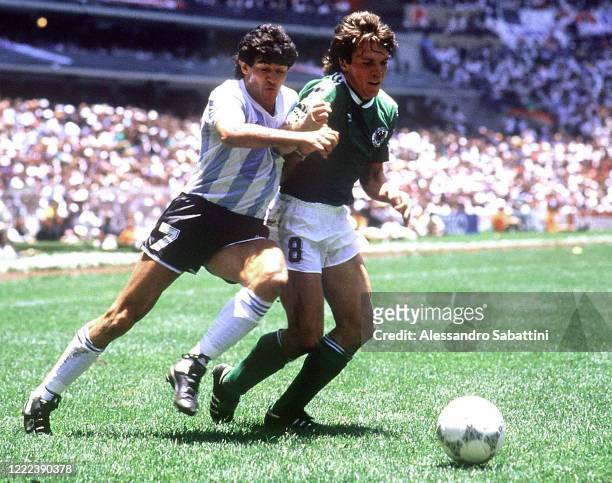 Jorge Luis Burruchaga of Argentina competes for the ball with Lothar Matthaus of Germany during the FIFA World Cup Final 1986 match between Argentina...