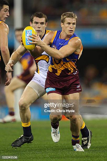 Luke Power of the Lions looks to pass during the round 23 AFL match between the Brisbane Lions and the West Coast Eagles at The Gabba on August 27,...