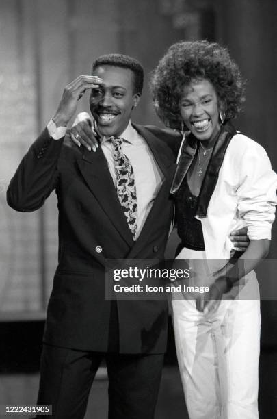 American comedian, talk show host, actor, writer and producer Arsenio Hall and American singer and actress Whitney Houston during a taping of The...