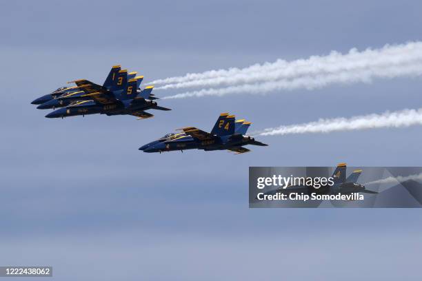 The U.S. Navy Blue Angels fly across the nation's capital during a tribute to healthcare workers, first responders, members of the military and other...