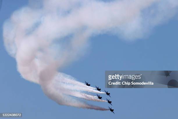 The U.S. Navy Blue Angels fly across the nation's capital during a tribute to healthcare workers, first responders, members of the military and other...