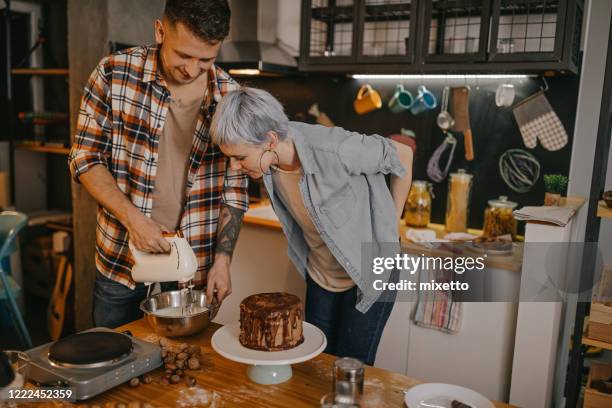 couple making cake at home - wife beater stock pictures, royalty-free photos & images