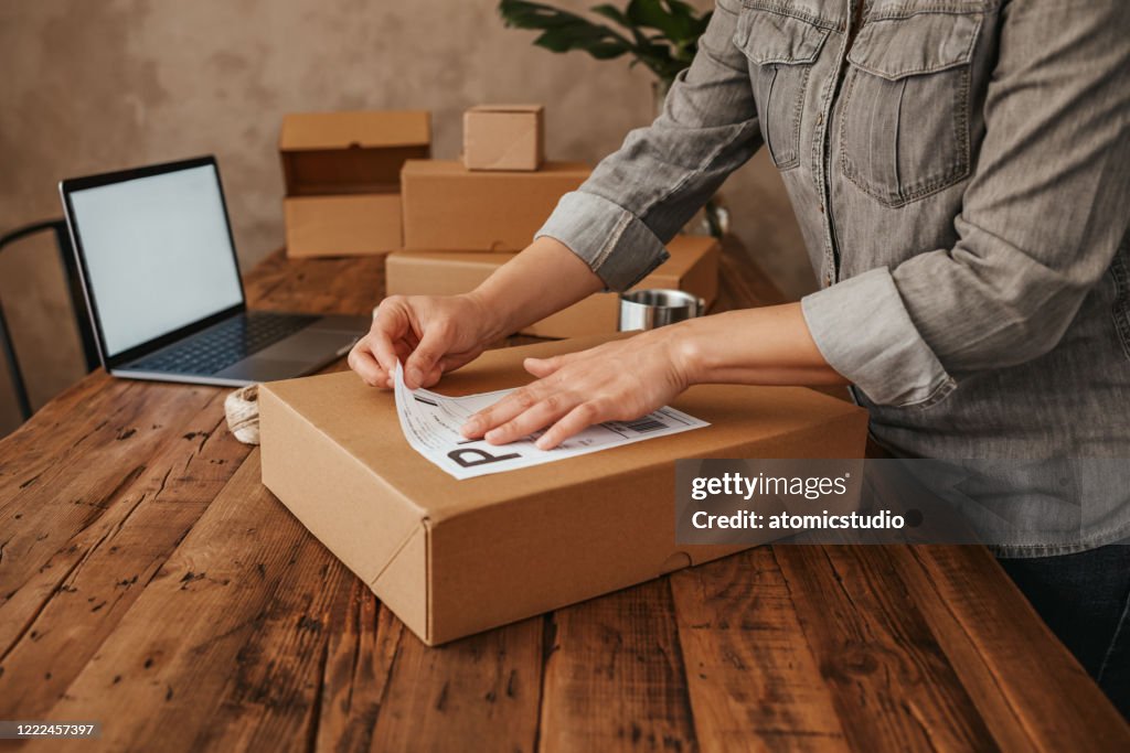 Female entrepreneur preparing the shipment for delivery. Small Business Owner Stock Photo