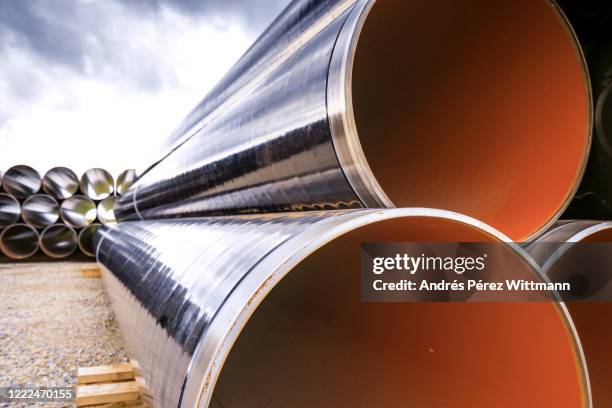 stacked gas pipes before burial - construction material foto e immagini stock