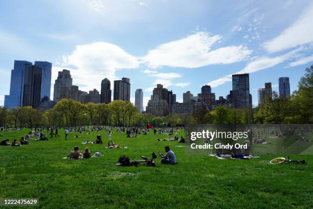 People fill Sheep Meadow in Central Park during the coronavirus pandemic on May 2, 2020 in New York City. COVID-19 has spread to most countries...