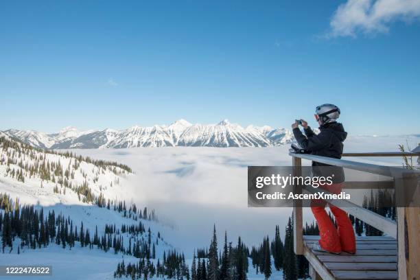 alpine skier relaxes above fog bank, mountains and valley - skier start stock pictures, royalty-free photos & images