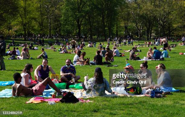 People fill Sheep Meadow in Central Park during the coronavirus pandemic on May 2, 2020 in New York City. COVID-19 has spread to most countries...