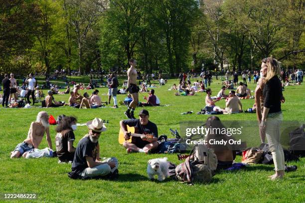 People fill Sheep Meadow in Central Park during the coronavirus pandemic on May 2, 2020 in New York City. COVID-19 has spread to most countries...