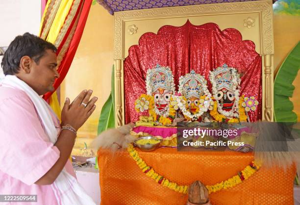 Priest offer prayers to Lord Jagannath at Sanwaliya Seth temple on the occasion of the Rath Yatra festival.