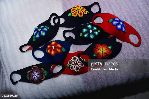 Protective masks made of Huichol handicraft as a preventive measurement against coronavirus on May 01, 2020 in Mexico City, Mexico. Villanueva is...