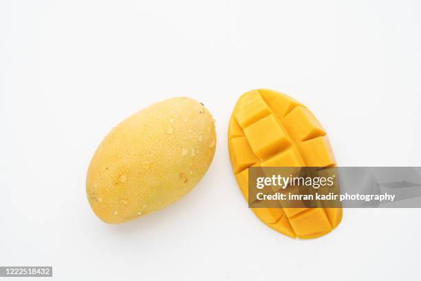 opened mango fruit at white table taken from above - mango pieces ストックフォトと画像