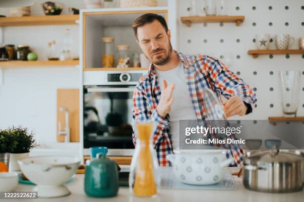 failed cooking in kitchen stock photo - disheveled man imagens e fotografias de stock