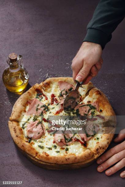 man cutting italian pizza - pizza with ham stock pictures, royalty-free photos & images