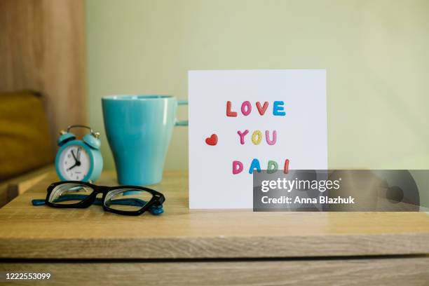 greeting card for happy father's day, on the bed, paper white sheet with text love you dad and heart, colorful letters - fathers day text stock pictures, royalty-free photos & images