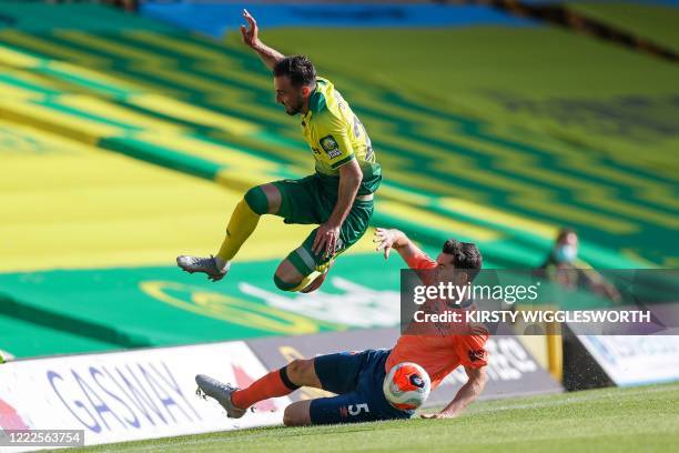 Norwich City's Swiss striker Josip Drmic vies for the ball with Everton's English defender Michael Keane during the English Premier League football...